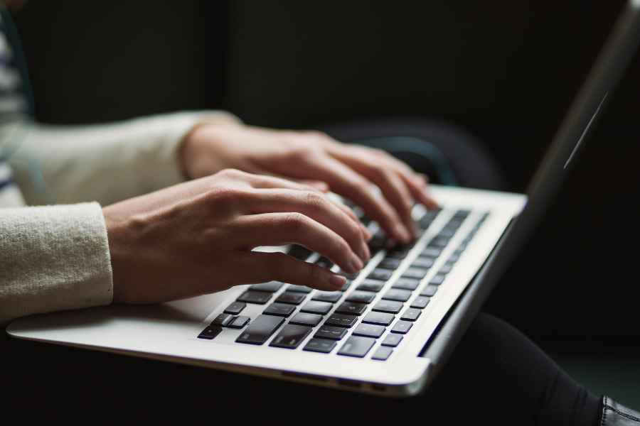 hands typing on a keyboard