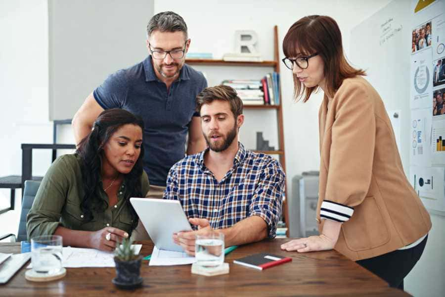 Four digital marketers in a meeting. 