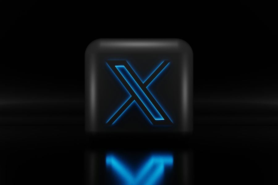 Twitter X logo on black block with blue light